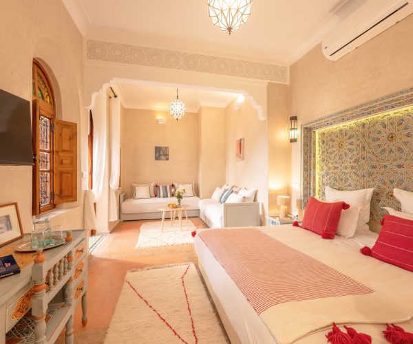 Traditional Moroccan riad courtyard at Dar Azal in Marrakech medina with zellige tiles and carved plasterwork